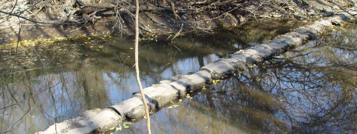 Exposed pipe in creek bed